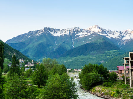 view of Mestia town with Mulkhra river and mountains in Samegrelo-Zemo Svaneti province of Georgia in summer evening twilightの写真素材