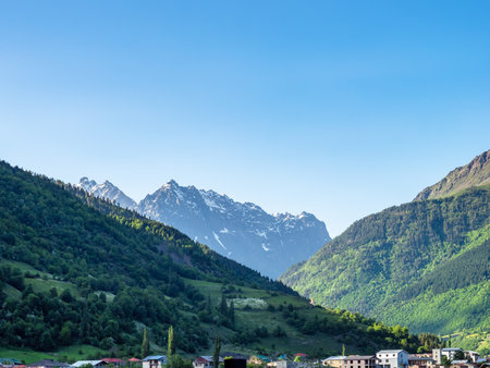 blue sky over Mestia town in mountain valley in Samegrelo-Zemo Svaneti province of Georgia on sunny summer dayの写真素材