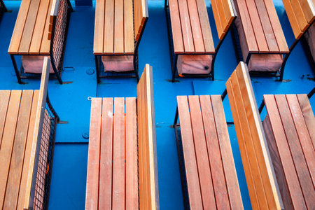 above view of empty wooden benches on board of sightseeing boat in rveningの写真素材