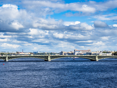 view of Trinity Bridge across Neva river in Saint Petersburg city, Russia on cloudy sunny summer dayの写真素材