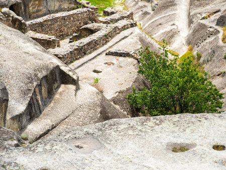 above view of roofs of stone caves in Uplistsikhe Cave Town, Georgia on sunny summer dayの写真素材