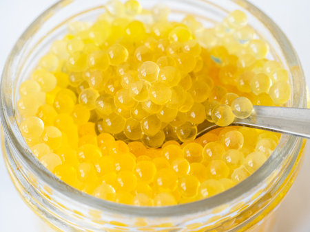yellow caviar of river rainbow trout fish closeup in glass jar from Armeniaの写真素材