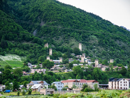 view of Mestia town on green mountain slope in Samegrelo-Zemo Svaneti province of Georgia in summer evening twilightの写真素材