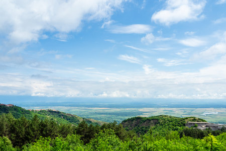 white clouds in blue sky over Alazani valley in background on summer morning, Georgia