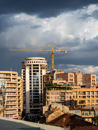 dark gray rainy clouds over urban houses in Yerevan city, Armenia on summer dayの写真素材