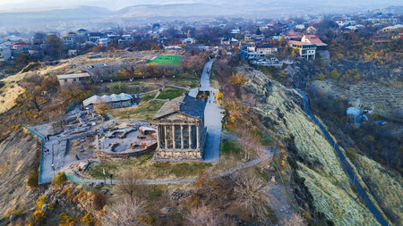 top view of Garni Temple and village in Azat Gorge in Kotayk region of Armenia on sunny autumn eveningの写真素材