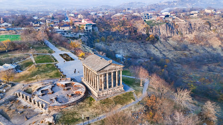 aerial view of Garni Temple and village in Azat Gorge in Kotayk region of Armenia on sunny autumn eveningの写真素材
