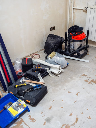 various construction tools on floor of room being prepared for renovationの写真素材