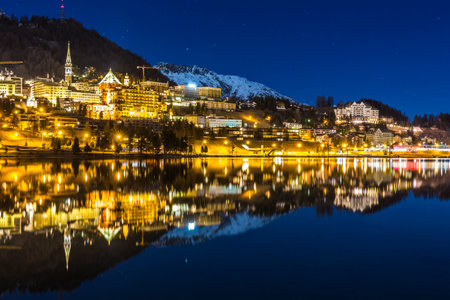 Night landscape of St Moritz reflected in the lake in Switzerland.