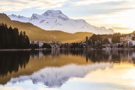 Landscape of St. Moritz. Church reflected on the river in winter.の写真素材