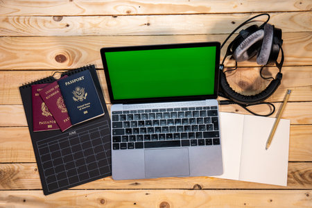 Plan the next summer vacation or a travel with your friends. Calendar, Italian and US passports, computer, headphones and notebook.の写真素材