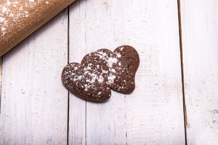 Chocolate cookies for the sweetest time of the year. Two cookies, one next to the other, with flour...