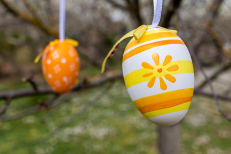 Happy Easter! Easter decorated eggs. Garden tree set up with multicolored Easter eggs.の写真素材