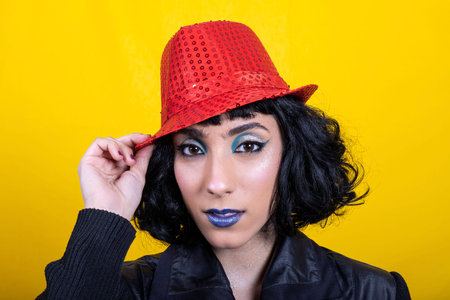 The young woman wears a red hat for the party. Beautiful woman has fun at the party. Concept of...