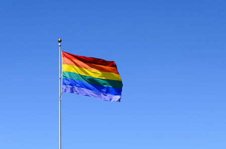 Rainbow flag of lgbt movement with beautiful skyの写真素材