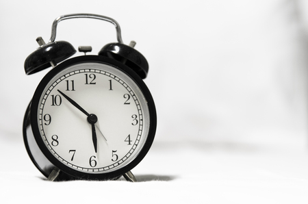 Early morning with retro style alarm clock in bedroomの写真素材