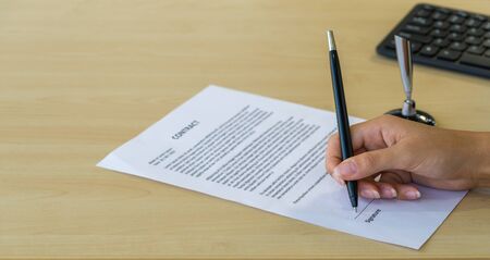 Job interviewers put a sign on the contract after being considered by the HR department.の写真素材