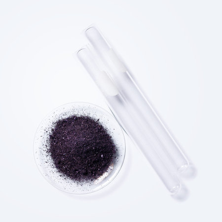 Potassium permanganate (KMnO4) and test tube on white laboratory table.の写真素材