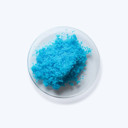 Close up inorganic chemical on white laboratory table. Copper(II) sulfate in Chemical Watch Glass.