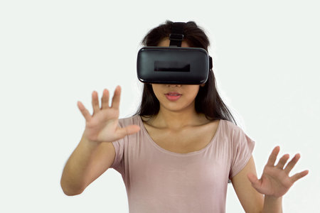 Asian teen using virtual reality glasses, play an interactive game. Future Technology Concept.