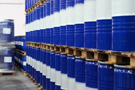 Blue chemical barrels with white stripes line up in chemical storage of industrial factories.の写真素材