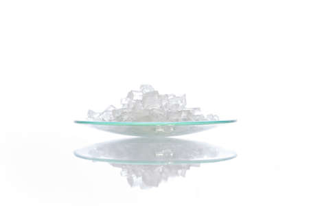 Closeup chemical ingredient on white laboratory table. Sodium Thiosulfate in Chemical Watch Glass. Side Viewの写真素材