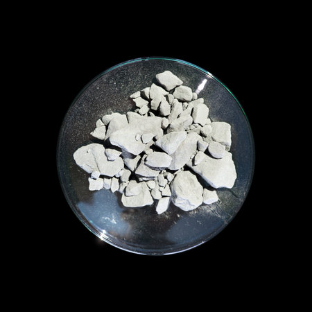 Aluminium powder in Chemical Watch Glass. Close up chemical ingredient on black table. Top View