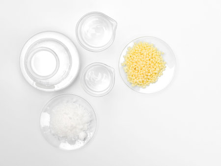 Cosmetic chemicals ingredient on white laboratory table. Cetyl esters wax, Candelilla Wax, alcohol.