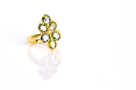 Green Sapphire and Diamond Jewel or gems ring on white background with reflection. Collection of...