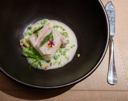 Alaskan Cod steamed, green peas, ebiko and lemon in cream sauce. Main course menu in fine dinning...