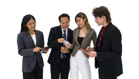Team of successful young people standing together. Some people drink coffee some people using tablet...