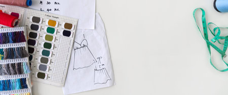 Pattern for cloth, silk thread color sample catalog, tape measure and sketching place on a large...