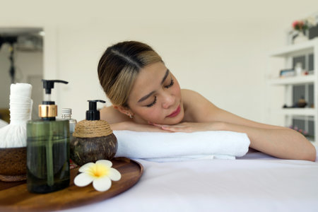 Holistic luxury wellness experience. A serene woman reclining leisurely within a soothing spa ambiance, surrounded by elements promoting tranquility.の写真素材