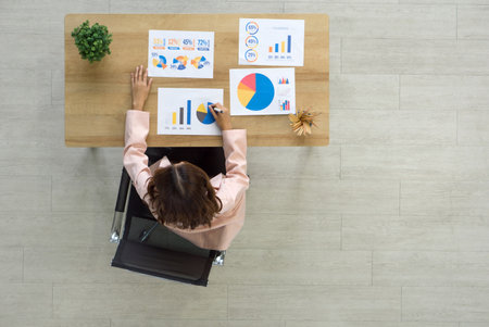 Professional woman analyzing data at a modern workplace. Top viewの写真素材