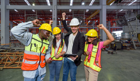 Celebrating Success. Hardhat construction worker raising their hand high, marking a victorious moment.の写真素材