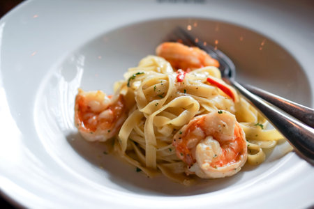 Tagliatelle spaghetti with shrimp, made simple way with garlic, chili, olive oil, parsley and parmesan cheese. Pasta plate in Argentina steakhouse restaurant.の写真素材