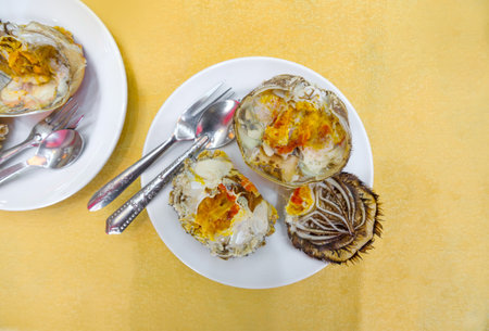 Steamed female crab with the roe inside served on white plate in the restaurant during Hairy Crab Festival. Chinese mitten crab is an important part of Shanghai cuisine.の写真素材