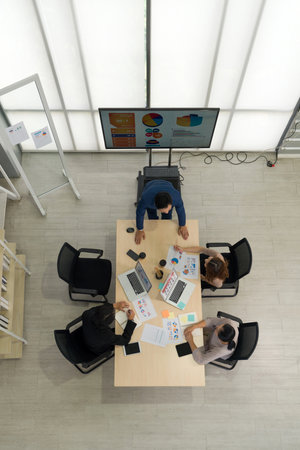 Business executive team meeting  in modern office with laptop computer, tablet, mobile phone and coffee on table. People corporate business team concept. Top Viewの写真素材