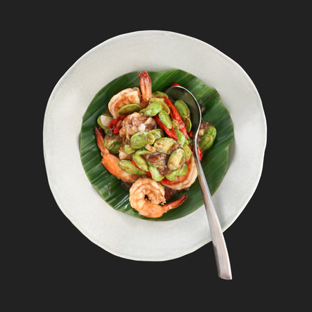 Stir-fried bean with prawn and fresh chilli. Thai style stir-fried vegetable decorated with banana leaves served on white plate. Top viewの写真素材