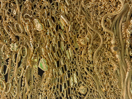 A jewelry store showcase an extensive collection of gold jewelry, including chain and necklace. The stall attract customer with its eye-catching display filled with shining treasure.の写真素材