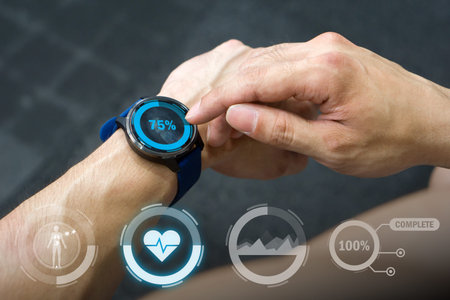 In a gym setting, an individual review health statistic on a smartwatch while exercising. The device...