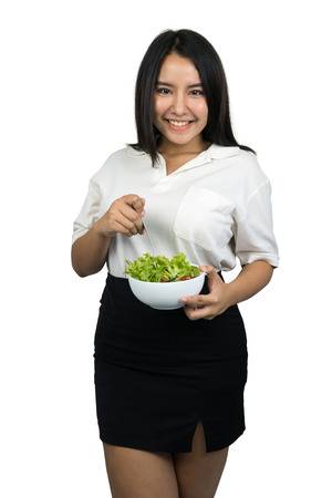beautiful plus size Asian woman holding a bowl of salad, isolated on white backgroundの写真素材