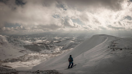 Skier skiing on mountain on a cloudy dayの写真素材