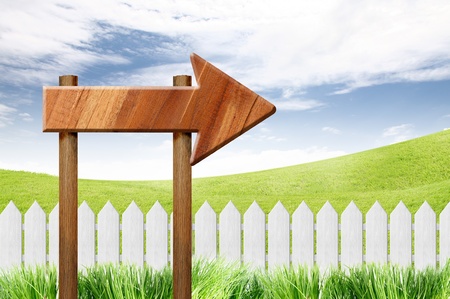 wooden sign and White fence on clear blue sky の写真素材