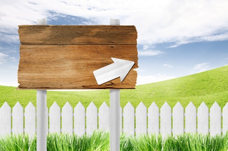 wooden sign and White fence on clear blue sky の写真素材