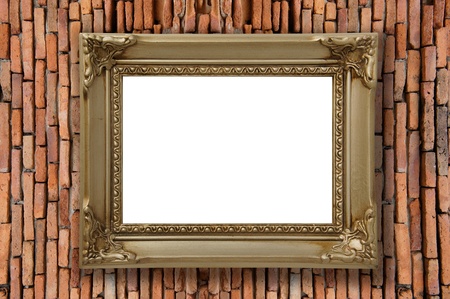 old brick wall with a blank gold picture frameの写真素材