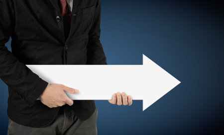 hands holding white arrow sign (path in side)