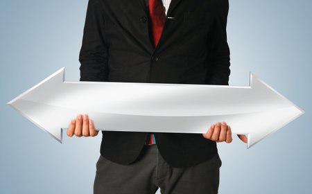 hands holding white arrow sign (path in side)