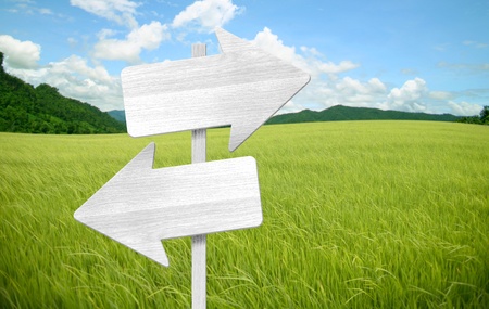 wooden sign on field grass mountainの写真素材