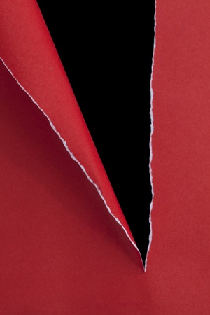 red ripped paper on dark backgroundの写真素材